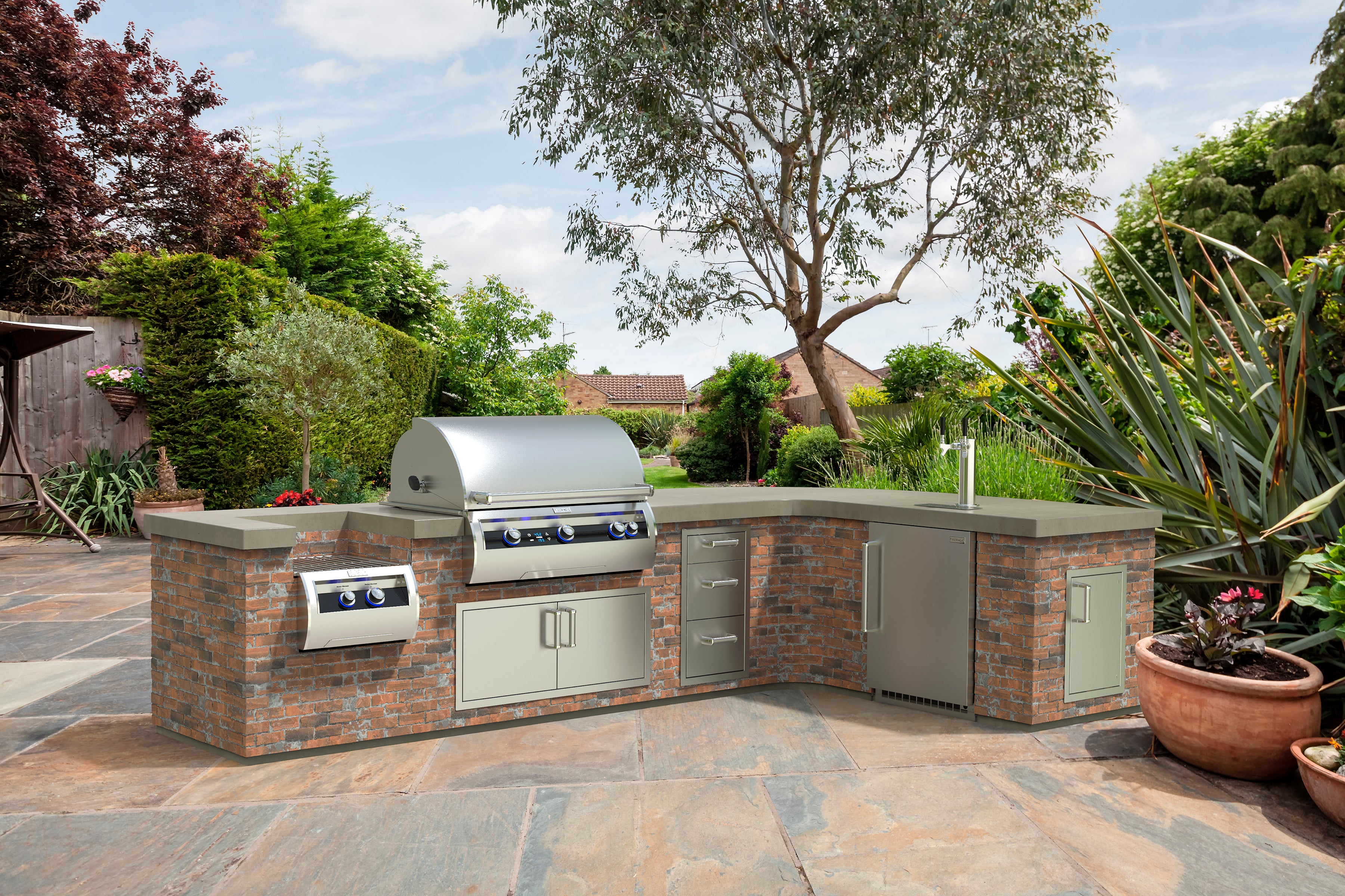 Luxury brick outdoor kitchen featuring built-in stainless steel gas grill, additional cabinets, and storage, with plenty of space to entertain guests around it.
