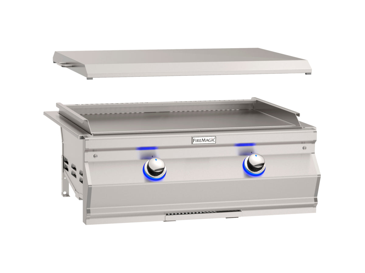 “Fire Magic 30″ built-in gourmet griddle with stainless steel cooking surface and dual burner control knobs in outdoor kitchen setup, perfect for pancakes, burgers and stir-fry.